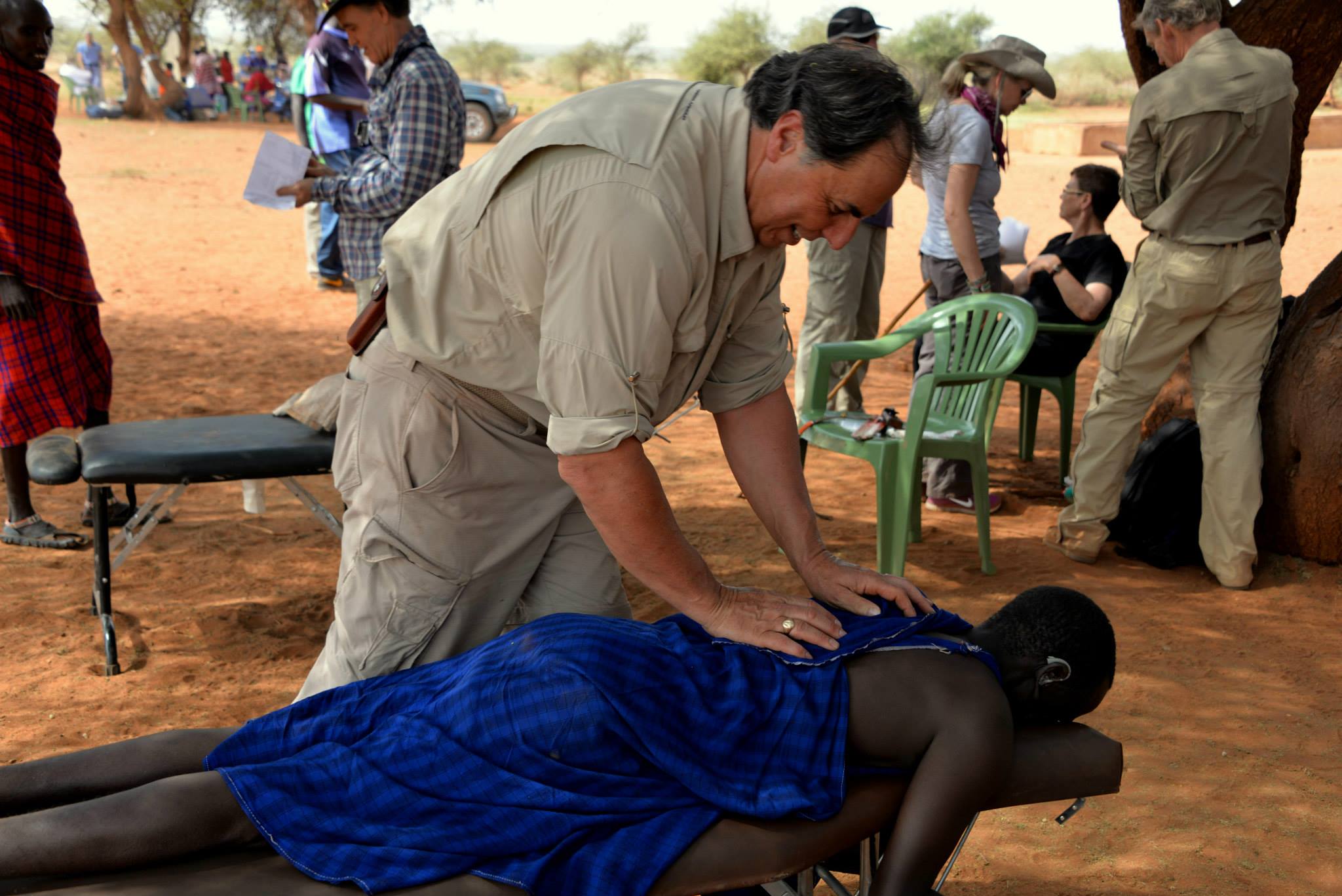Jeff Kahrs, DC, adjusting the spine of a woman in Africa - 2014.